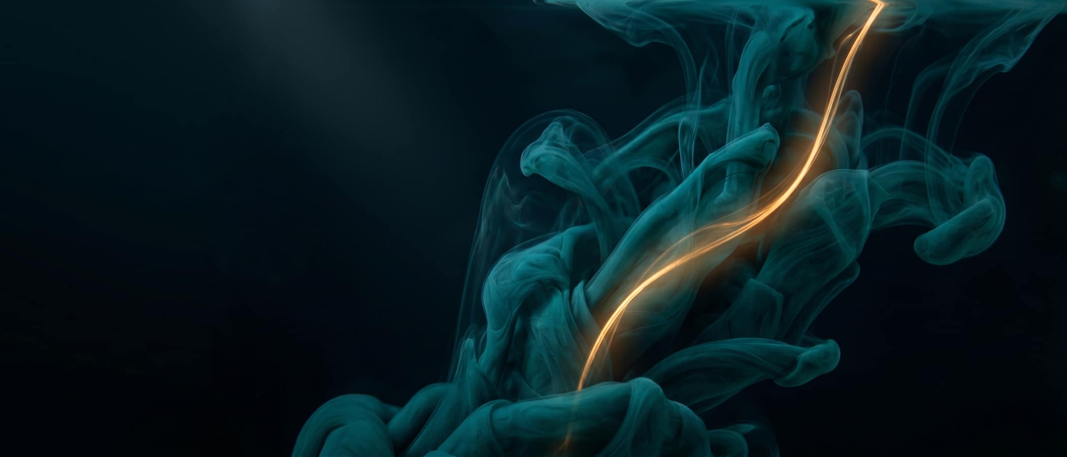 Teal ink swirling in dark water with one luminous amber filament