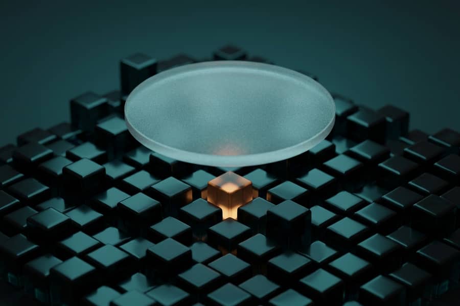 A frosted glass lens over a miniature dark city grid with one amber block