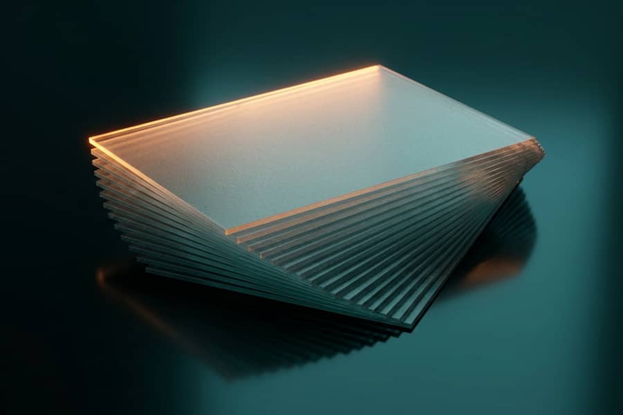 A fanned stack of frosted glass cards, the top edge lit amber