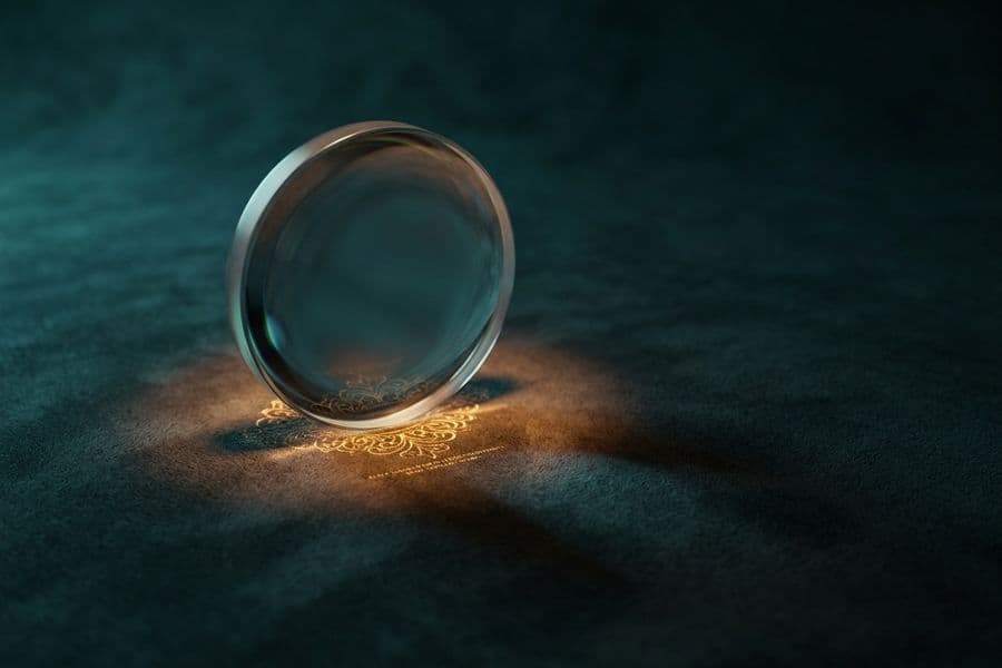 A glass lens revealing glowing detail on dark teal suede